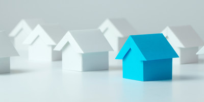 Single blue house among white houses